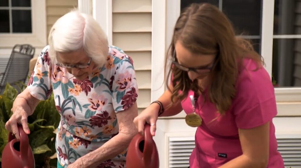 Certified Nursing Assistant (CNA) works with Kendal at Lexington resident